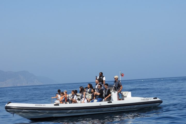 a group of people in a boat on a body of water
