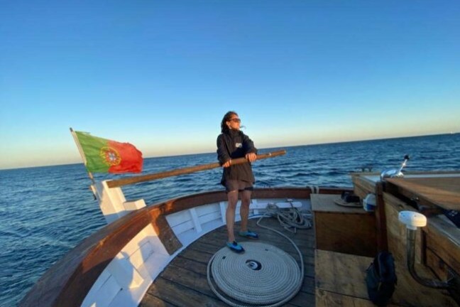 a person standing next to a body of water