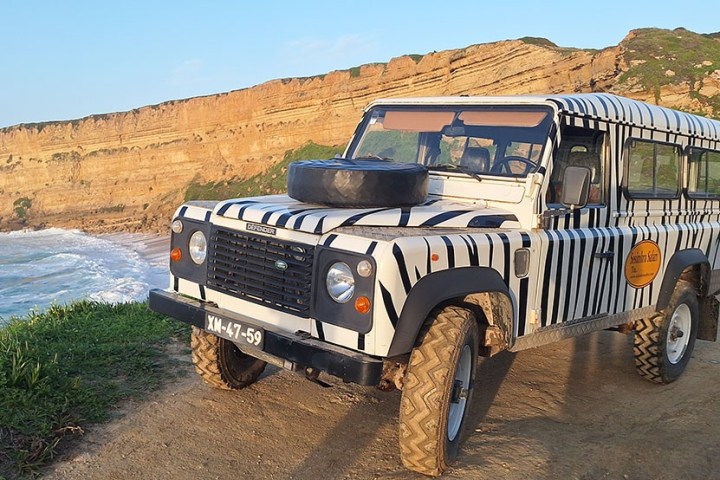 a truck driving down a dirt road