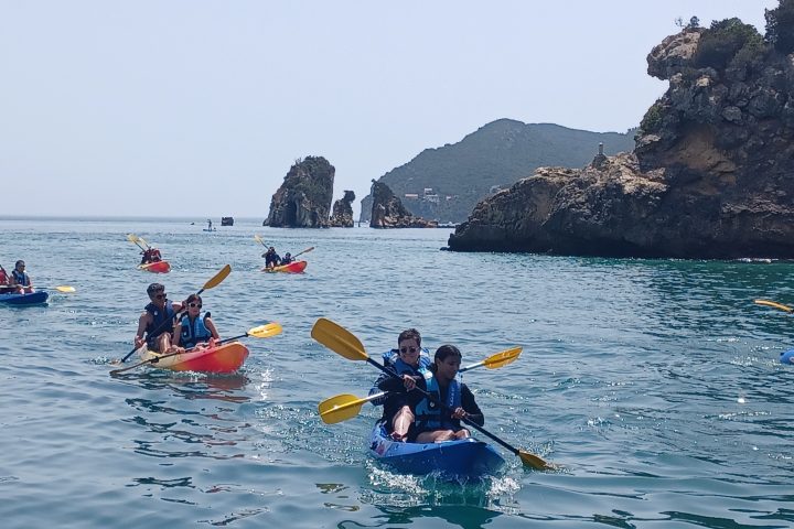 a group of people in a small boat in a body of water