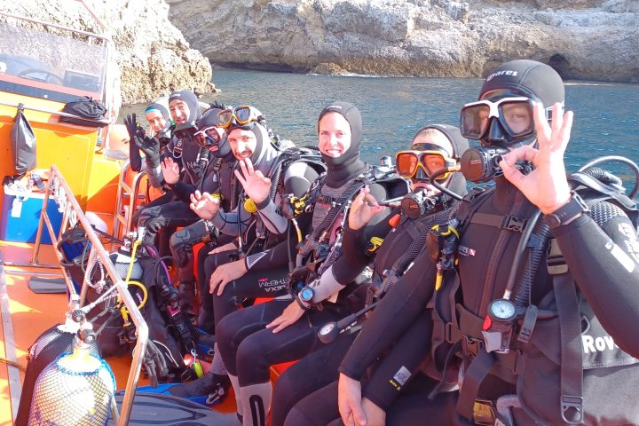 a group of people riding on the back of a motorcycle