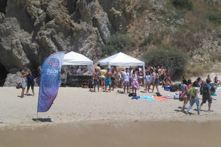 a group of people walking on a beach