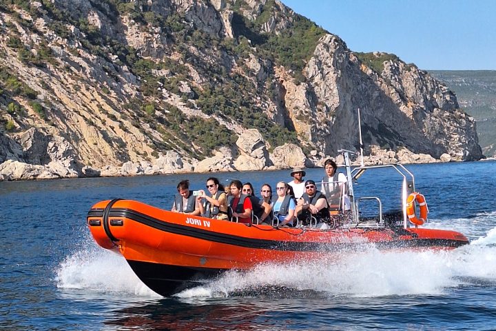 a small boat in a body of water with a mountain in the background