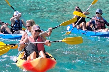 a group of people on a boat in the water