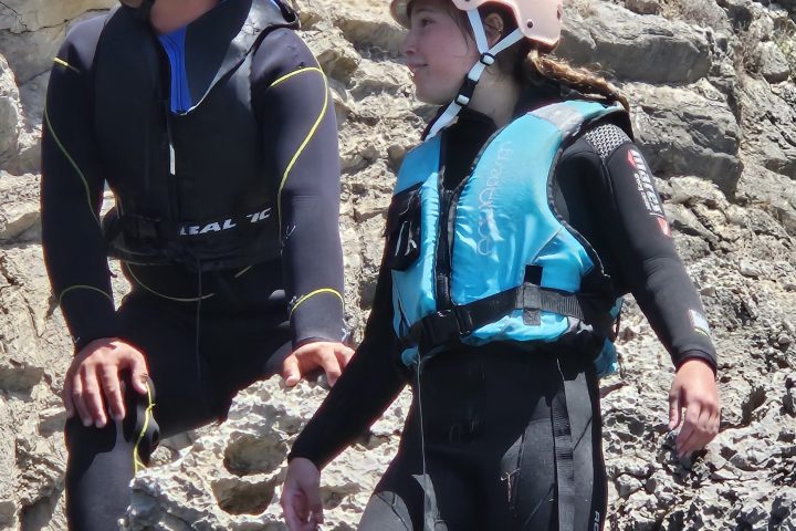 a couple of people that are standing in the sand