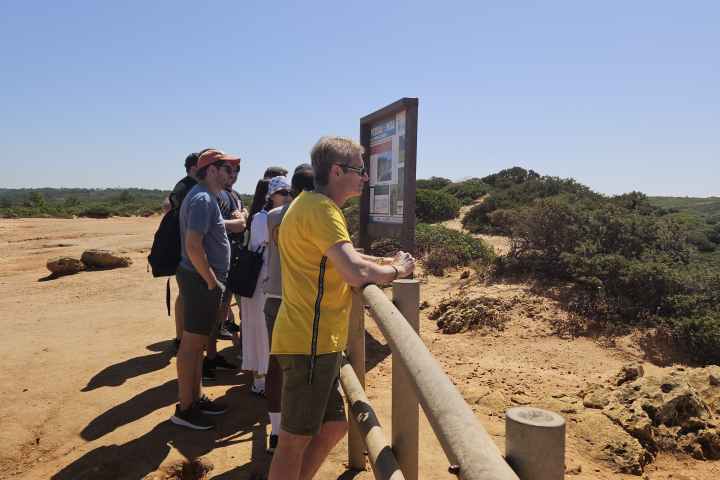 a man standing on a dirt road