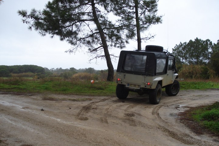 a truck driving down a dirt road
