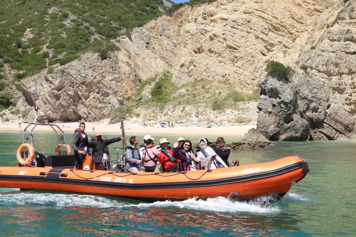 a group of people in a small boat in a body of water