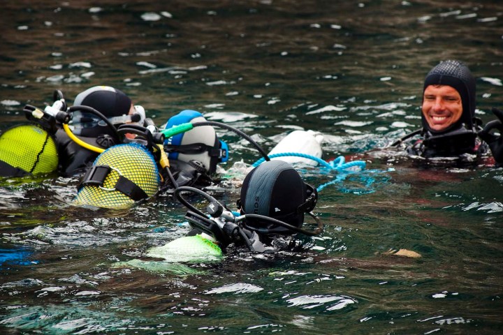 a group of people rowing a boat in a body of water