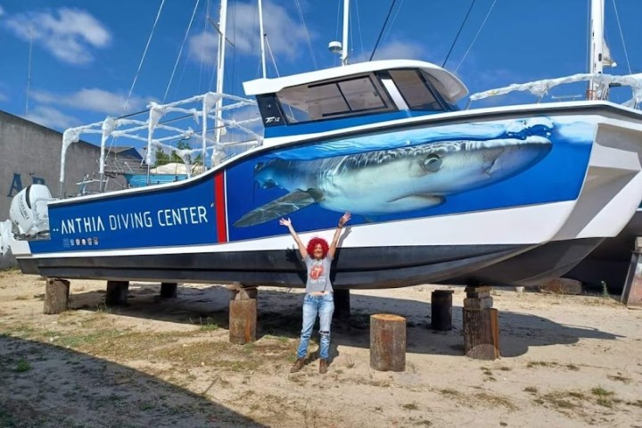a boat sitting on top of a dirt field