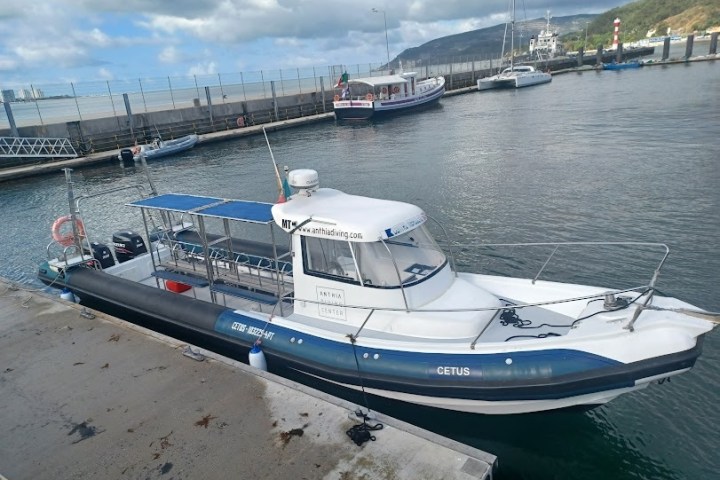 a boat is docked next to a body of water