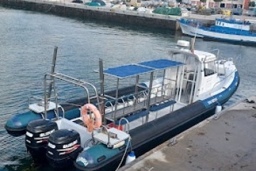 a boat is docked next to a body of water