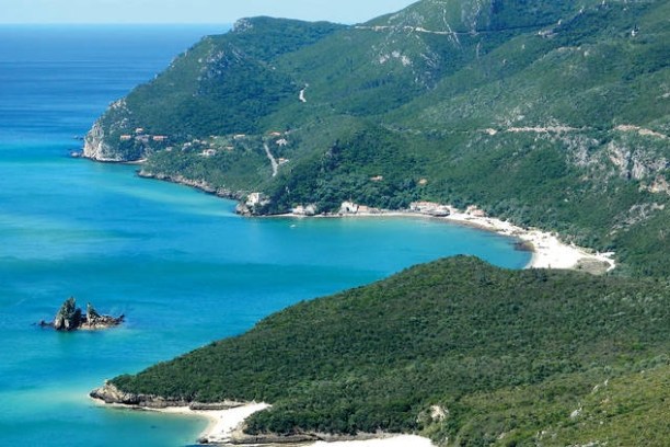 a body of water with a mountain in the ocean