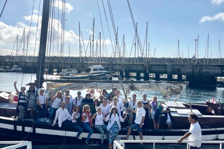 a group of people on a dock next to a body of water