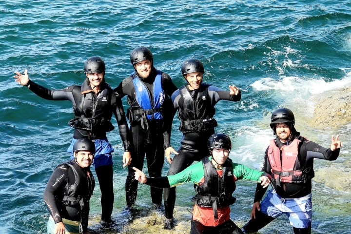 a group of people that are standing in the water