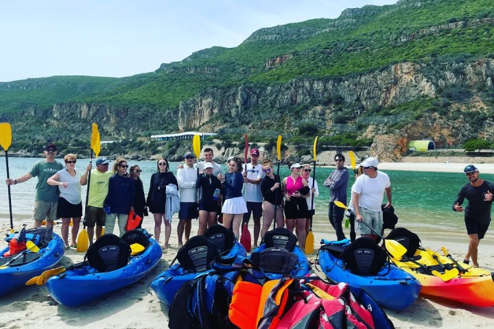 a group of people sitting at a beach