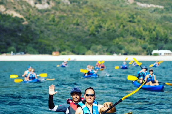 a group of people rowing a boat in the water