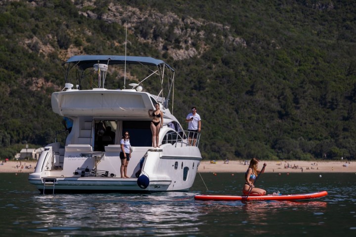 a group of people in a small boat in a body of water