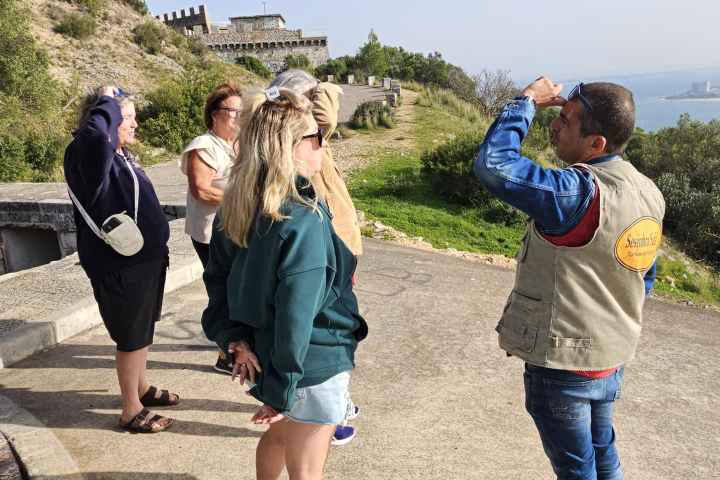 a group of people walking in the sand