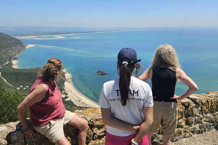 a group of people on a beach near a body of water