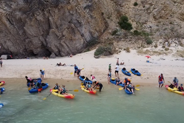 a group of people riding on the back of a boat
