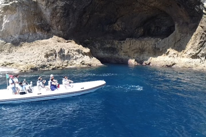 a boat in the water with a mountain in the background