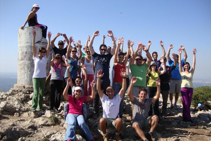 a group of people on a beach posing for the camera